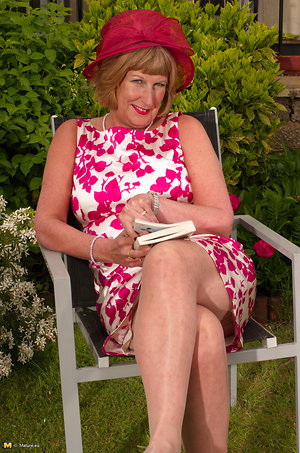 She opened the book  and she took the vibrator and began to caress her clitoris