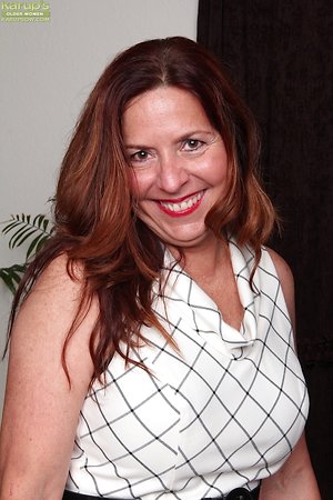 Auburn-haired mature touches her own tits and snatch in the solo pics