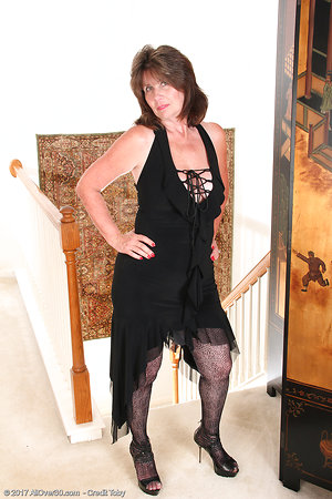 Smiling woman denudes at the second floor in mature porn pics