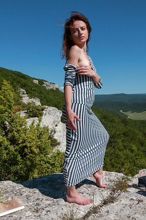 Petite hairy girl flashes muff after winning top of a rock