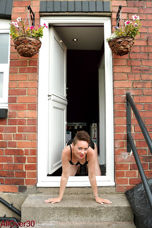 Outdoors nude posing of skinny woman with short haircut